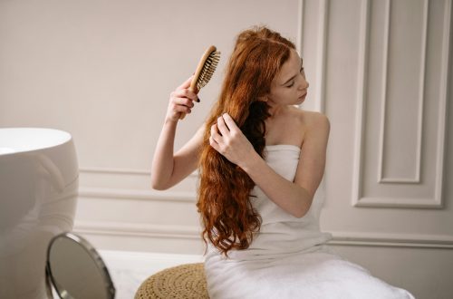 A woman after taking a shower uses one of the Top Detangling Brushes.