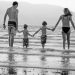 A perfect holiday family photo of a family in the beach.